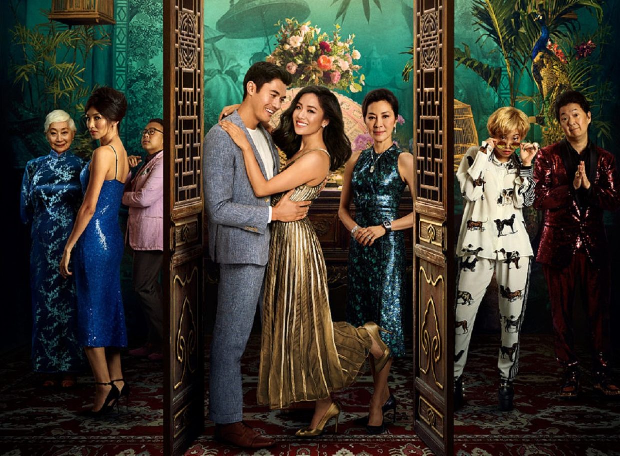 The main cast of the rom-com is assembled around an intricate Asian backdrop while posing.