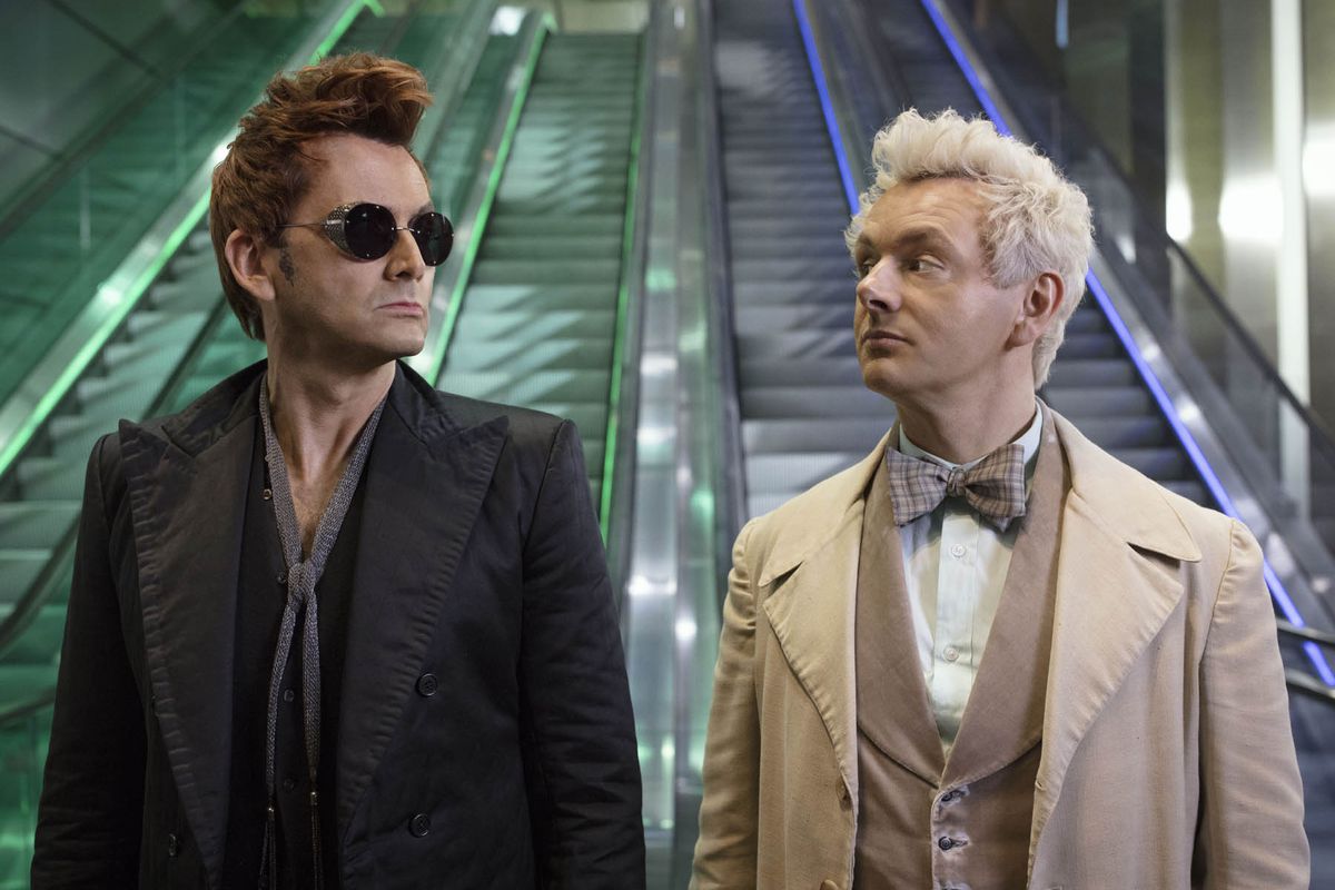 Aziraphale and Crowley stand at two elevators, symbolizing Heaven and Hell.