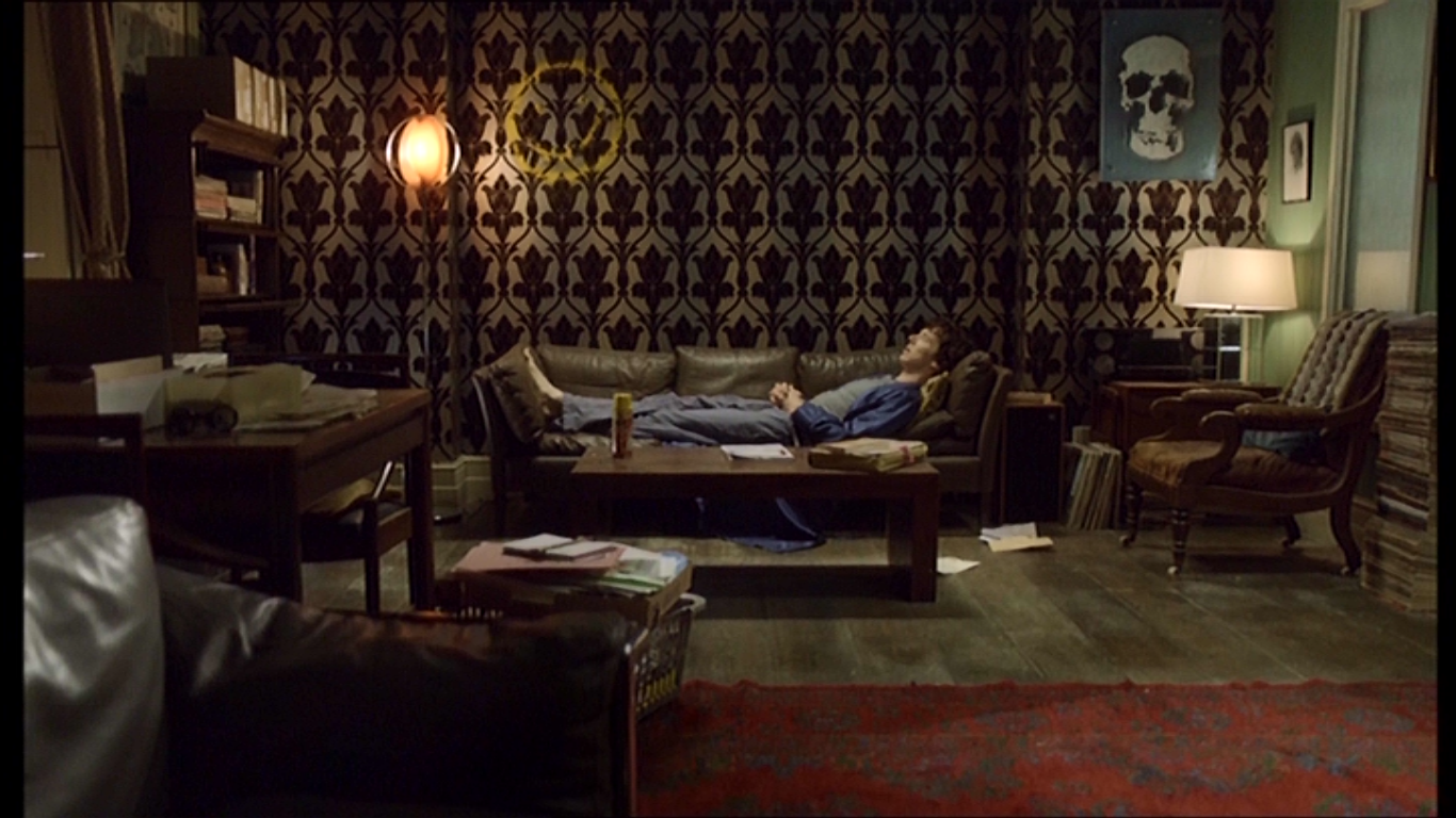 Sherlock lays on his couch, as if in quarantine, in 221B Baker St.