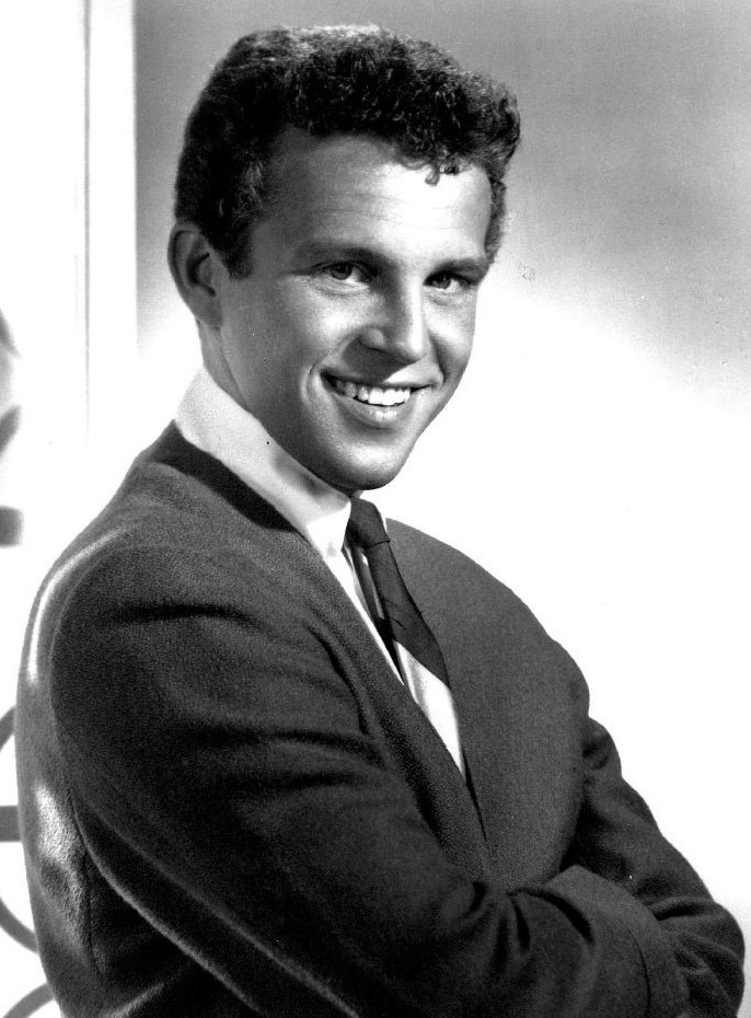 Bobby Vinton smiles with his arms crossed in black-and-white.