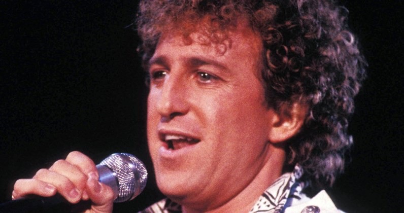 Matthew Wilder performs "Break My Stride" with a microphone in his hand.