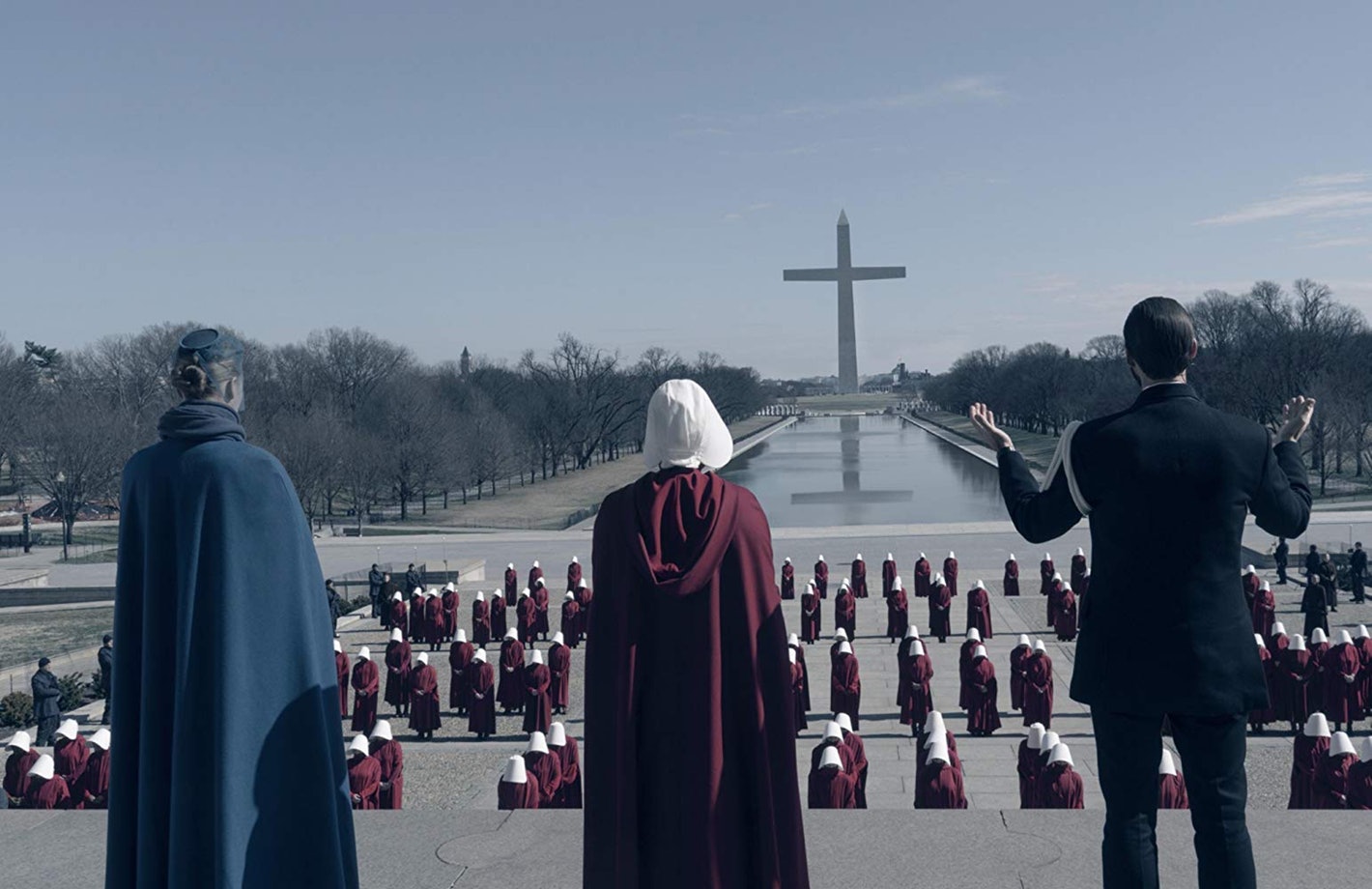 Serena Joy, June, and Fred Waterford begin leading prayer over other handmaids in Washington.