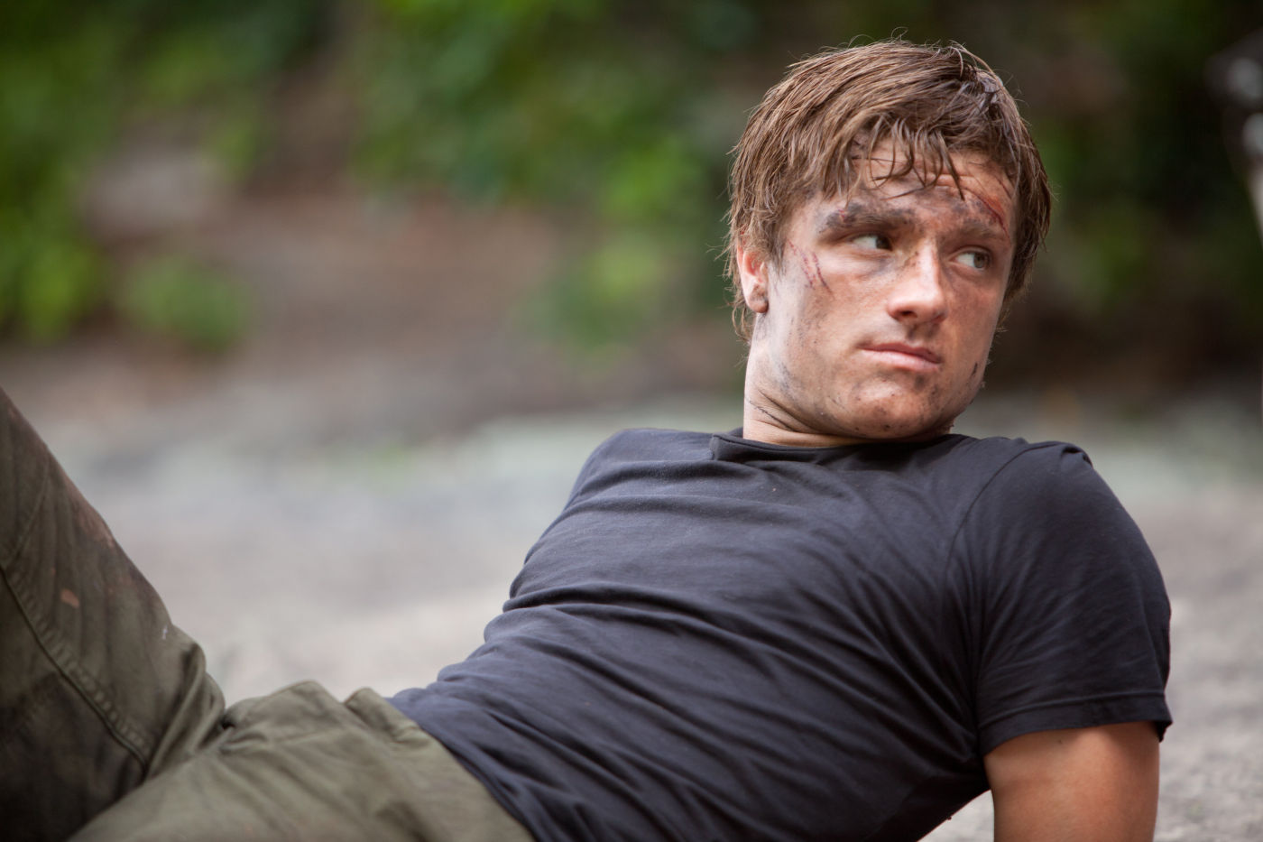 Peeta lays down, dirty in The Hunger Games film.