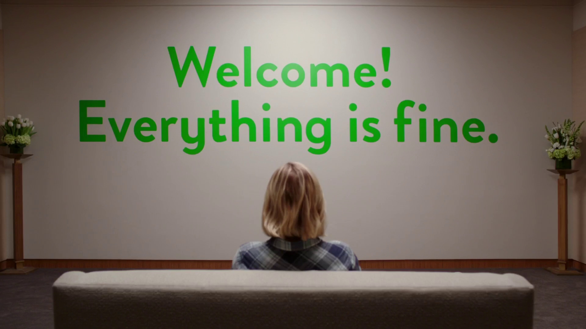 Eleanor looks at a sign that says "Welcome! Everything is fine." in The Good Place.