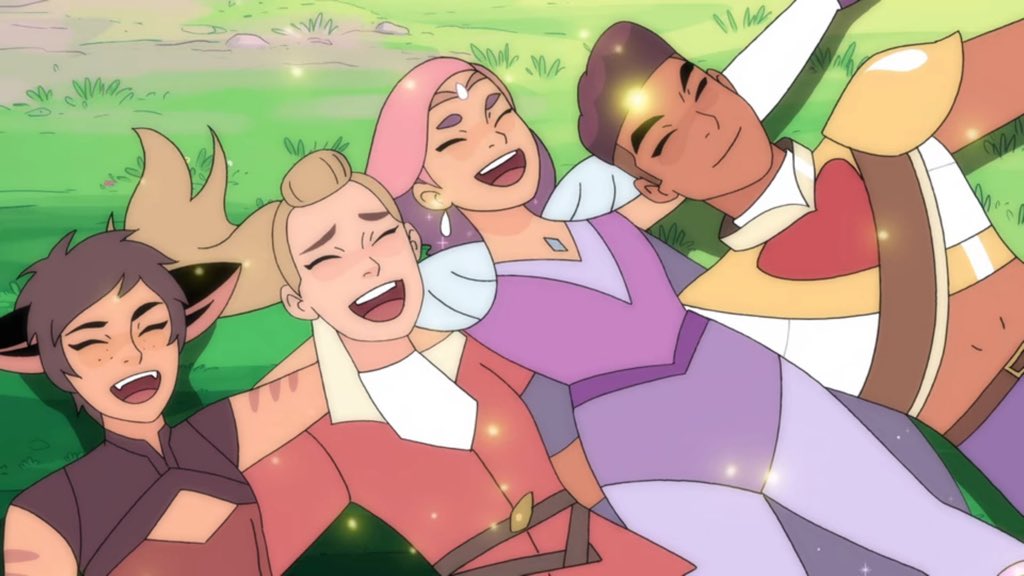 Catra, Adora, Glimmer, and Bow relax in a field after their victory