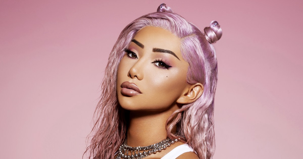 Nikita Dragun in front of a pink background
