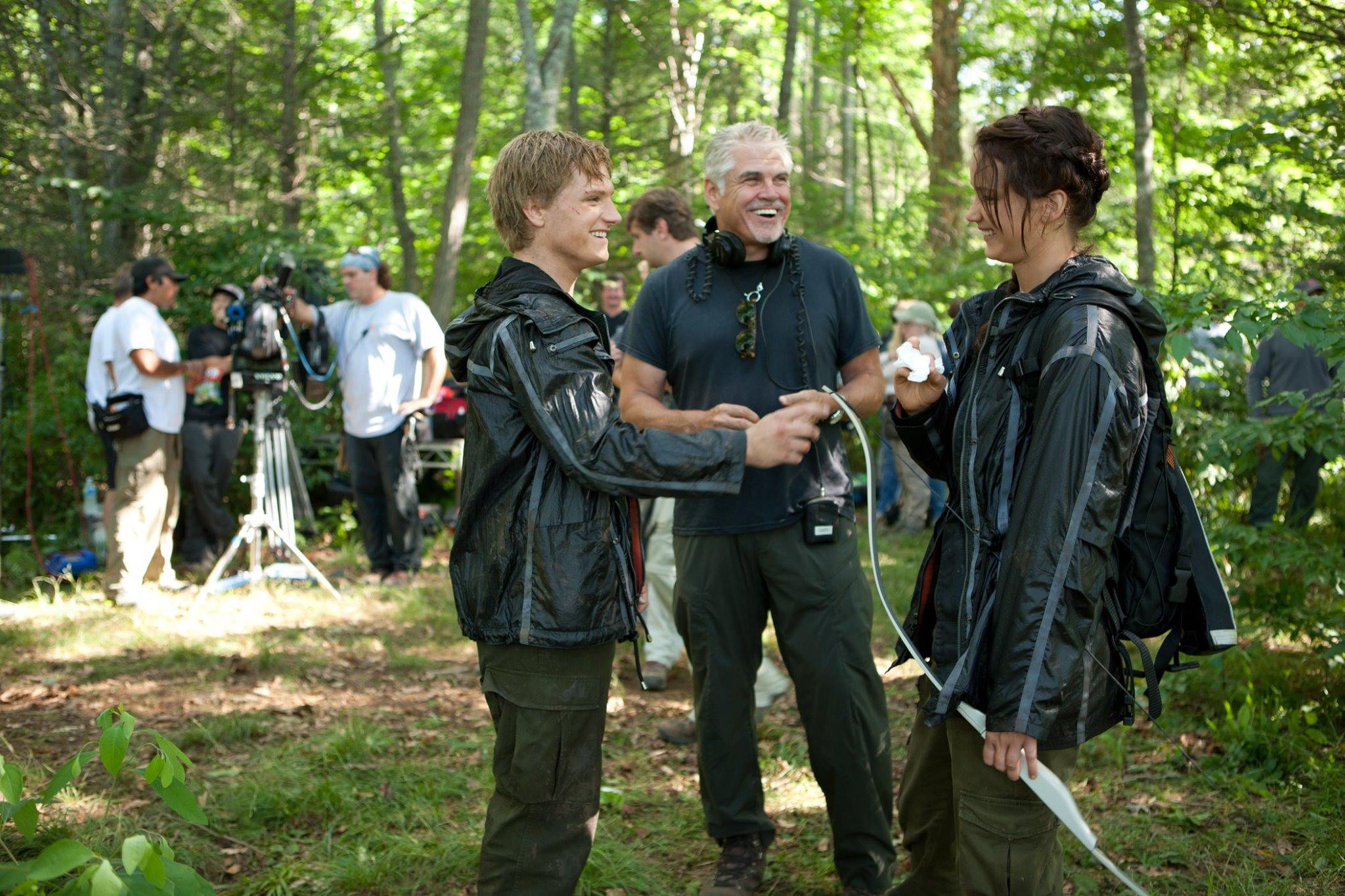 Josh Hutcherson, Gary Ross, and Katniss Everdeen laugh on the set of The Hunger Games.