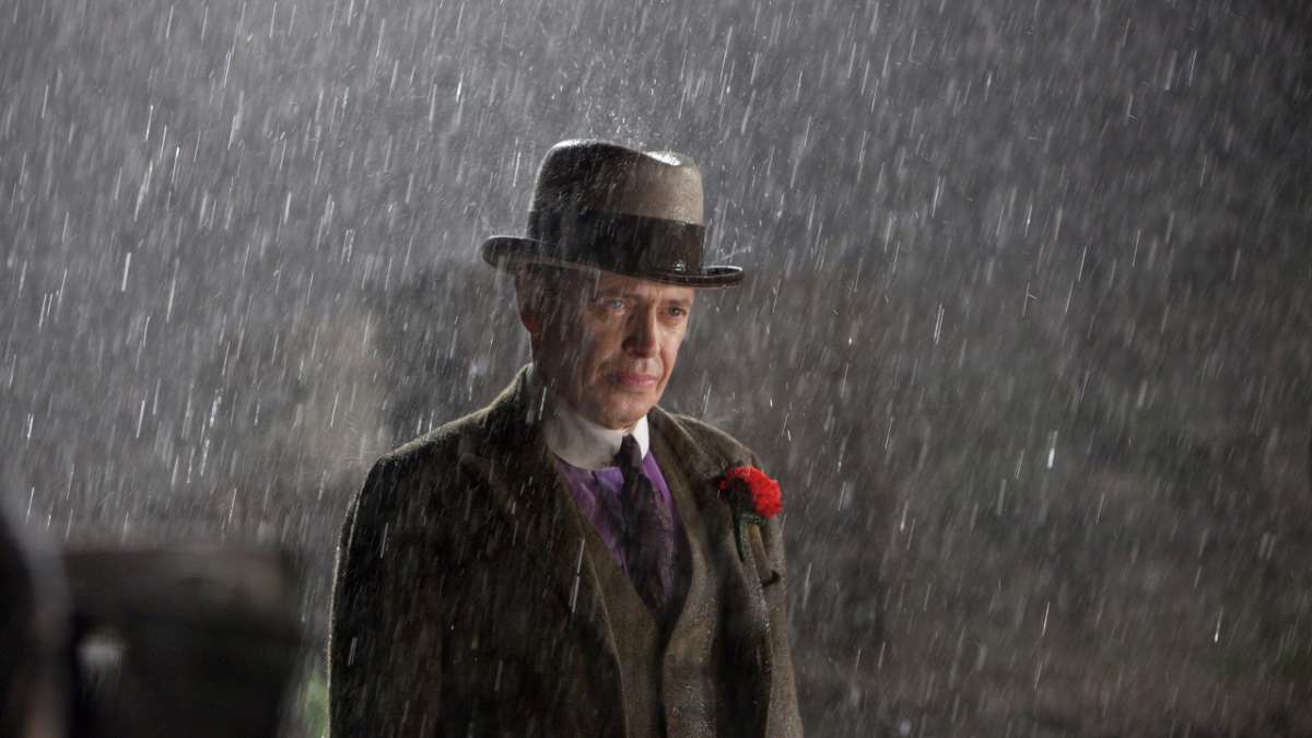 Nucky from Boardwalk Empire standing in the rain.