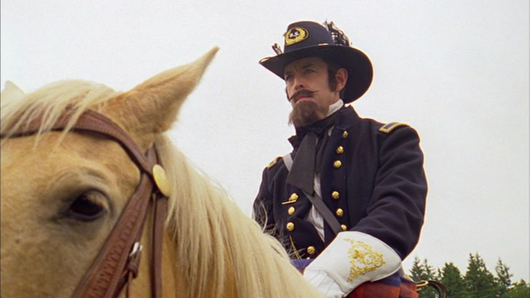 Detective Carlton Lassiter in his Civil War reenactment attire, complete with beard and mustache, sitting on a horse.