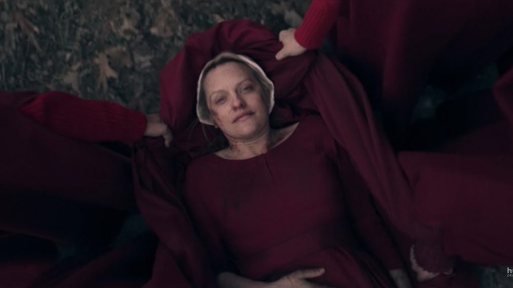 June gets lifted by other handmaids to safety at the end of Season 3. 