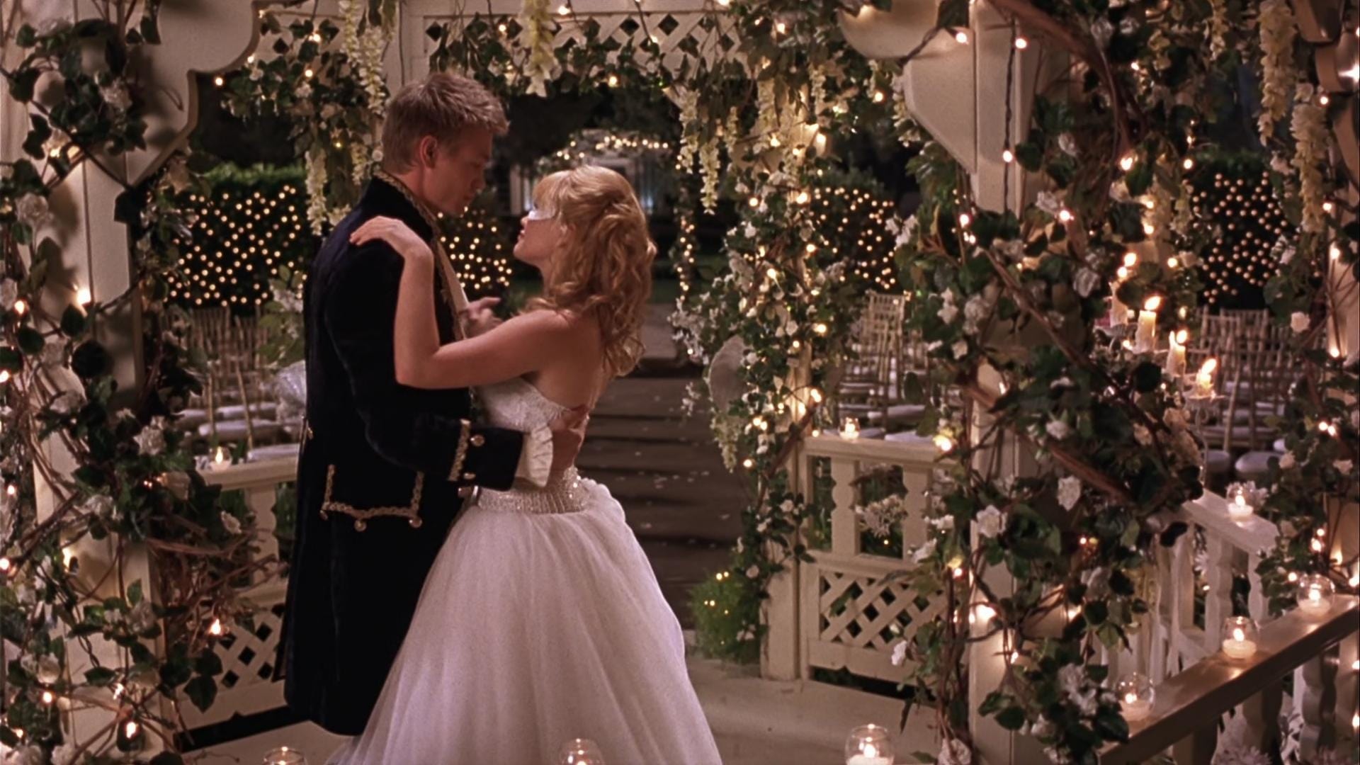 The young couple dances together under a gazebo while dressed in their Halloween costumes.