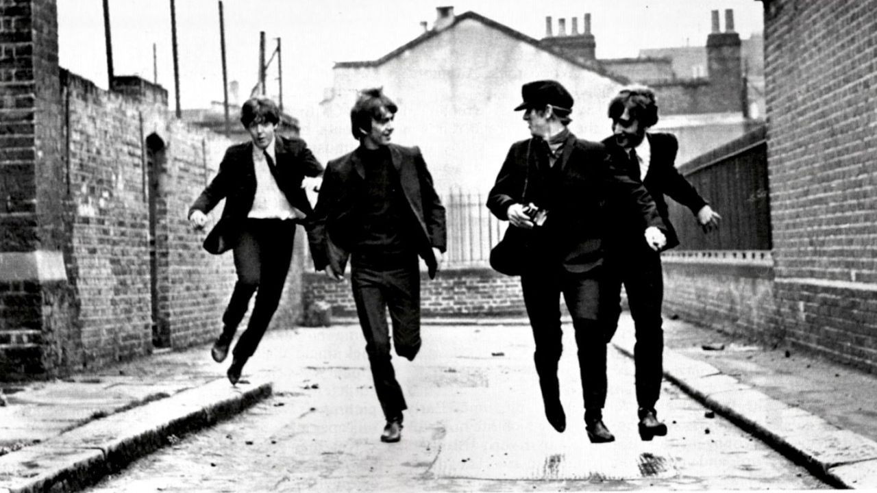 The Beatles run even when not pursued by fans in a still from their musical movie debut. 