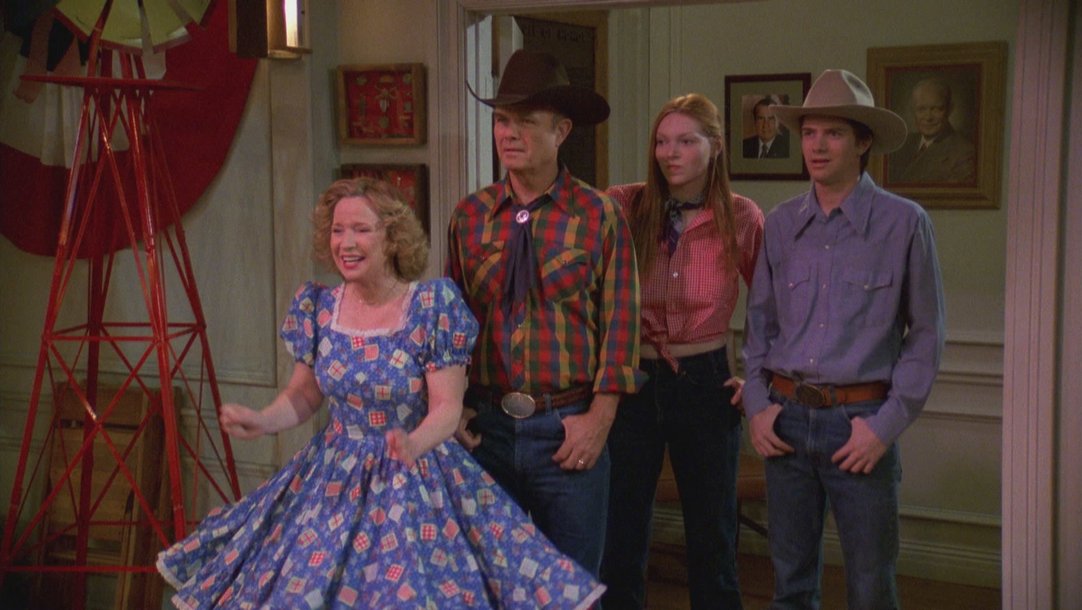 Mother's Day: The mother of the Formans, Kitty, looks ecstatic as she leads her family into a line dancing event. 