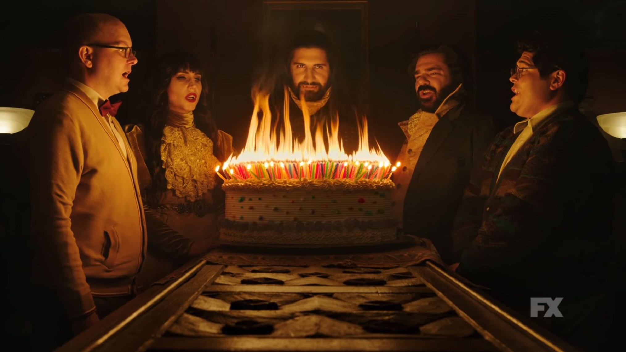 The main cast of FX's What We Do In The Shadows gathered around a birthday cake crammed full with hundreds of candles.