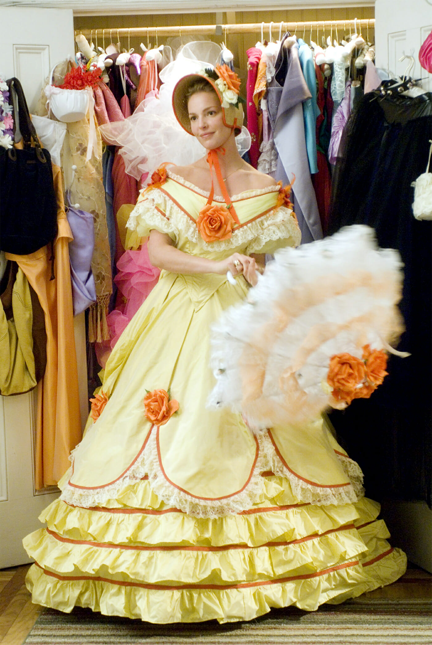 The protagonist of the rom-com poses in a large, frilly, yellow dress for the camera.