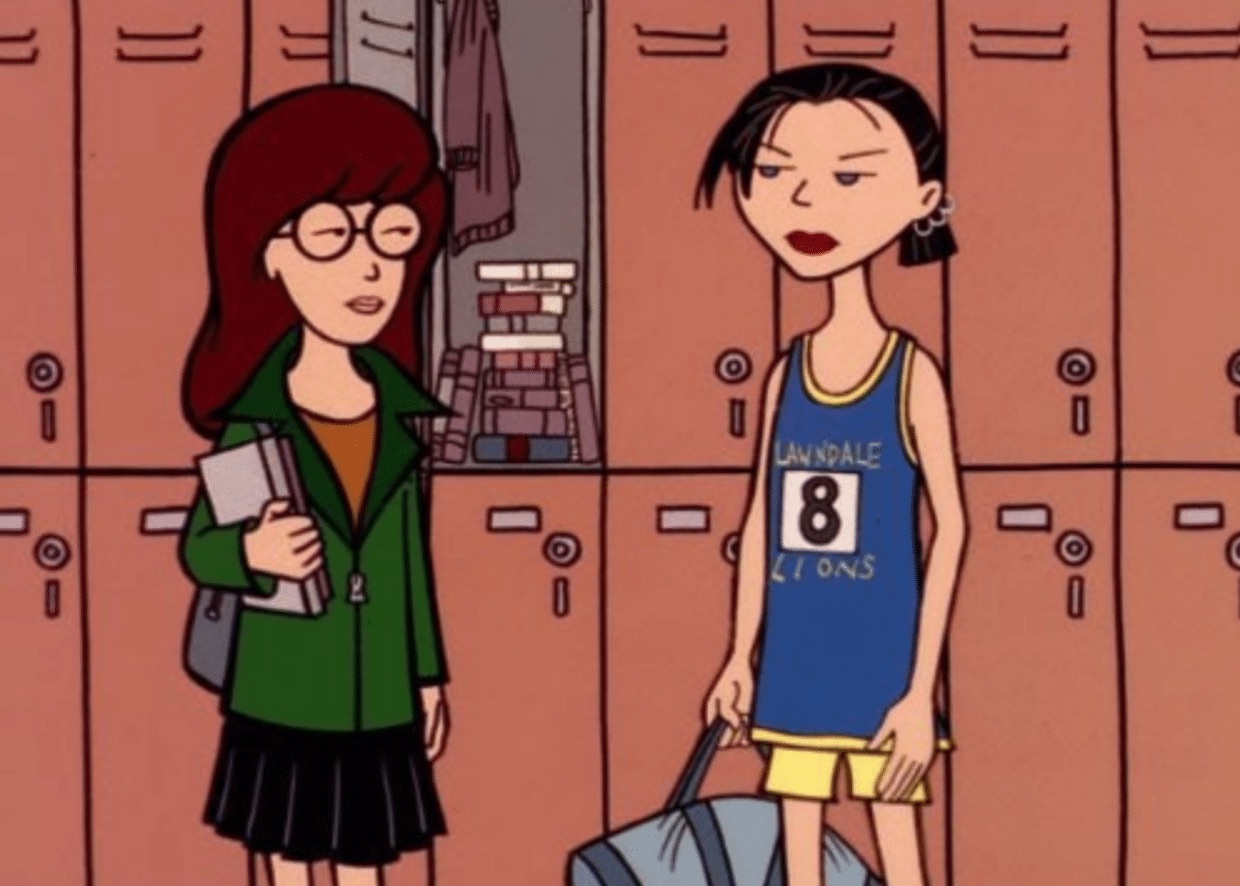 Daria stands in front of an open locker next to Jane, who is wearing a blue and yellow track uniform and is holding a gray duffel bag. 