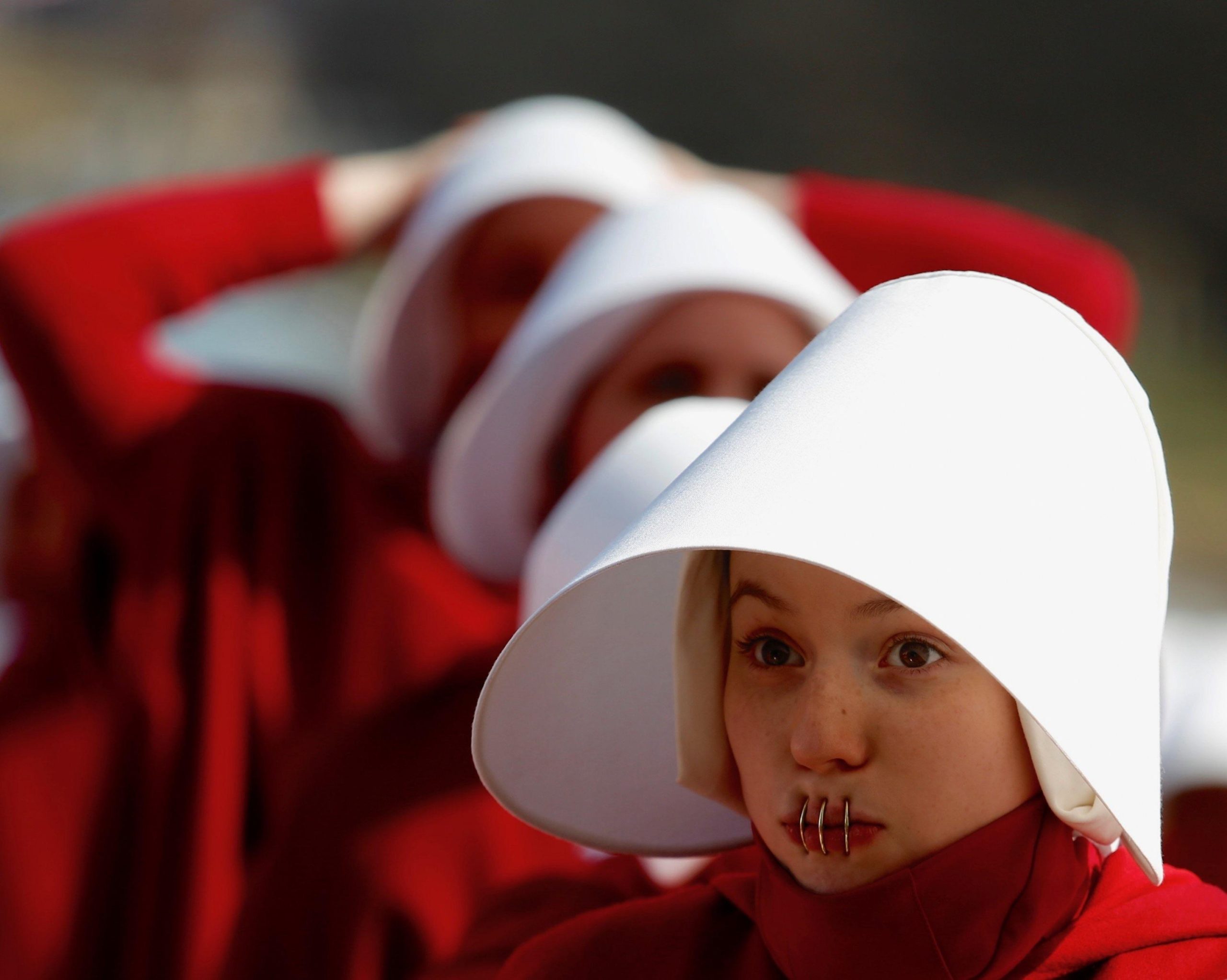 The handmaids in Washington are, "silenced" which means that, underneath their mouth veils, their lips are stapled shut. This keeps rebellion out of Washington. 