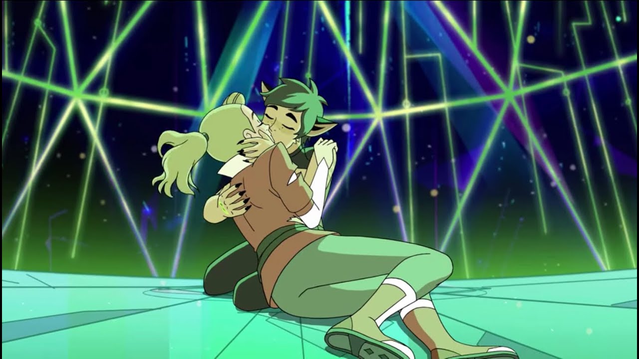 LGBTQIA+ representation in She-Ra with couple Catra and Adora kissing in a space ship full of green lgihts