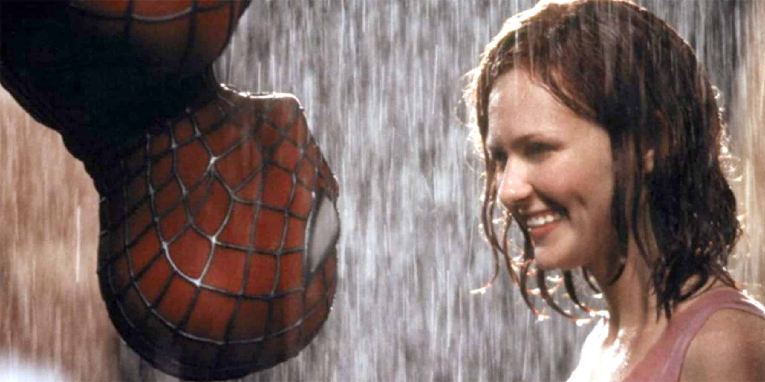 Spider-Man hangs upside-down looking at Mary-Jane, in the rain.