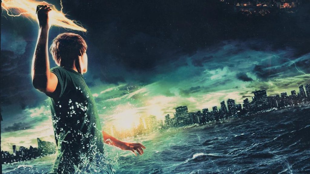 Percy Jackson stands in the war in front of New York City, holding a lightning bolt. 