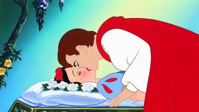 Snow White lying down while the prince charming kisses her