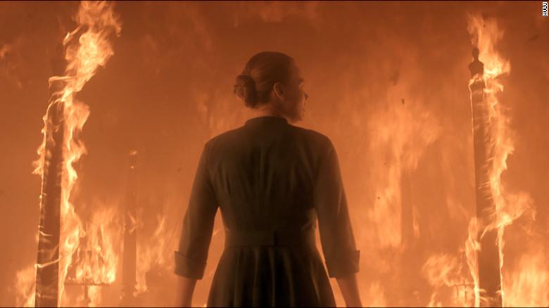 Serena Joy stands in front of her bed which is now on fire. 