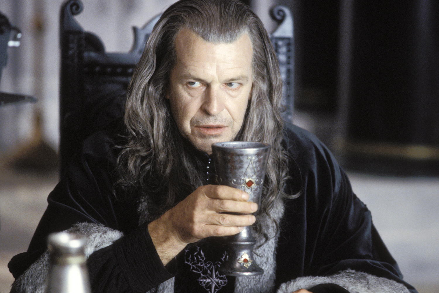 Denethor drinks wine as his youngest son fights a hopeless battle.