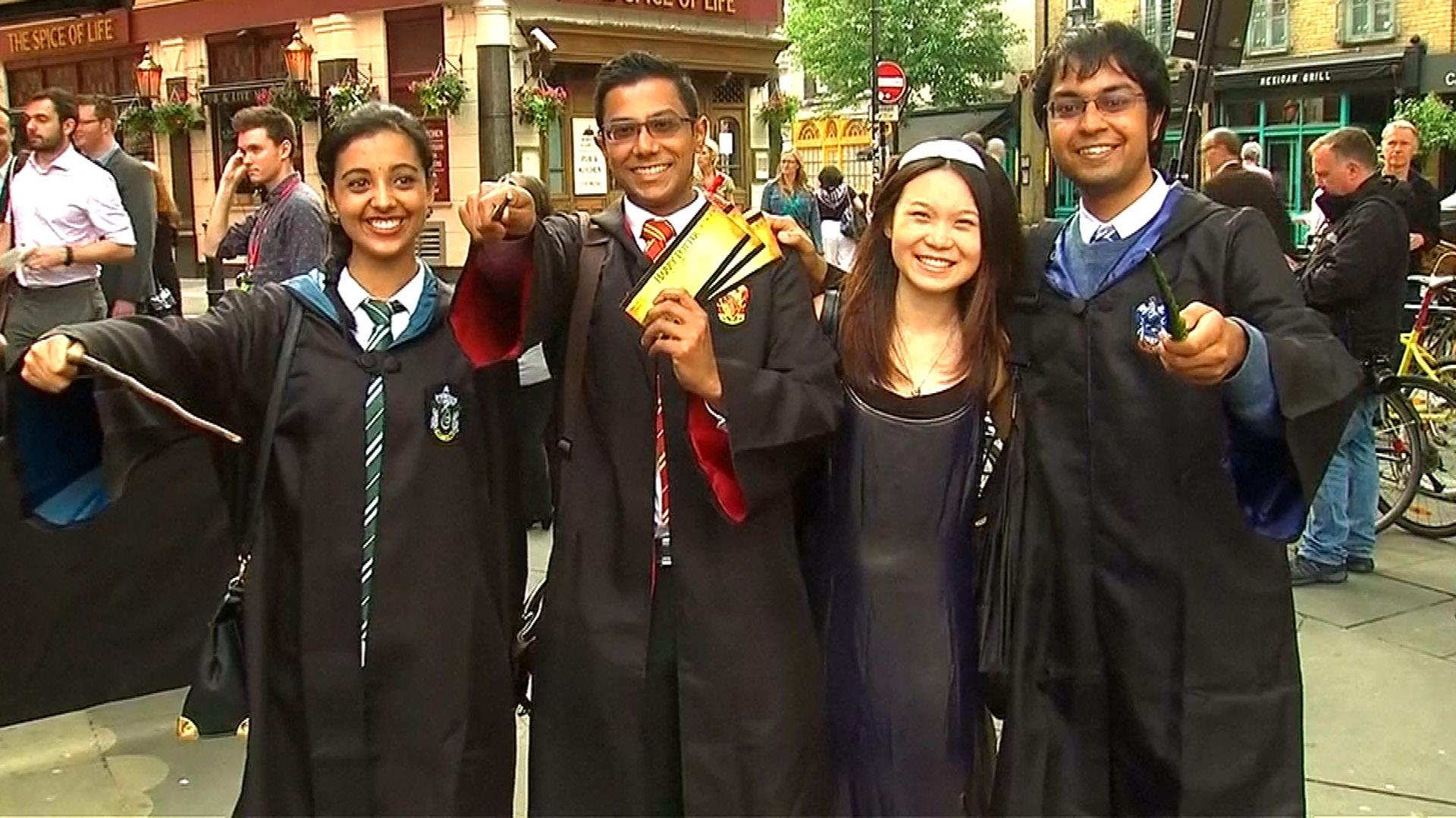 Four individuals from the Harry Potter fandom dressed up as Gryffindor, Ravenclaw, and Slytherin students. 