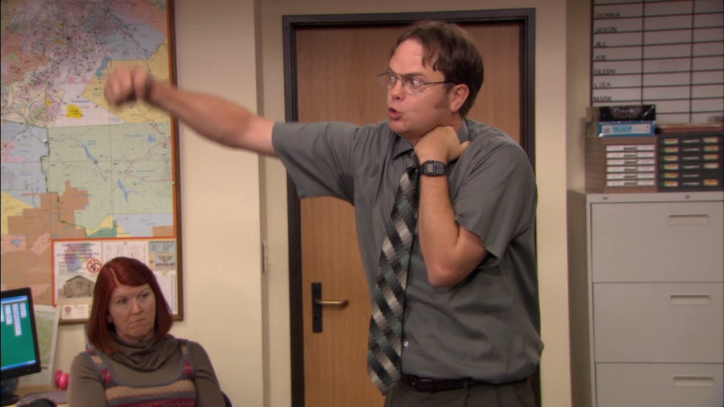 Dwight Schrute fights himself in front of the rest of his office co-workers. 