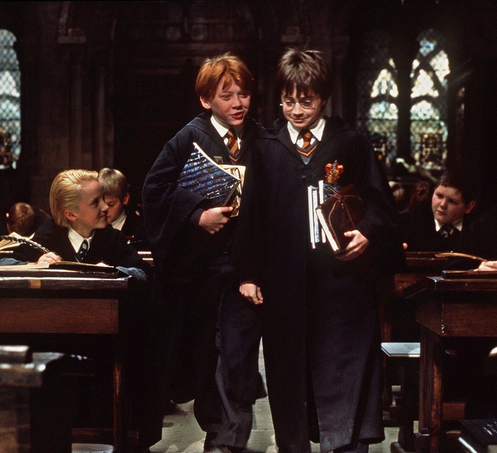 Harry Potter standing in front of his friends Ron Weasley and Draco Malfoy.