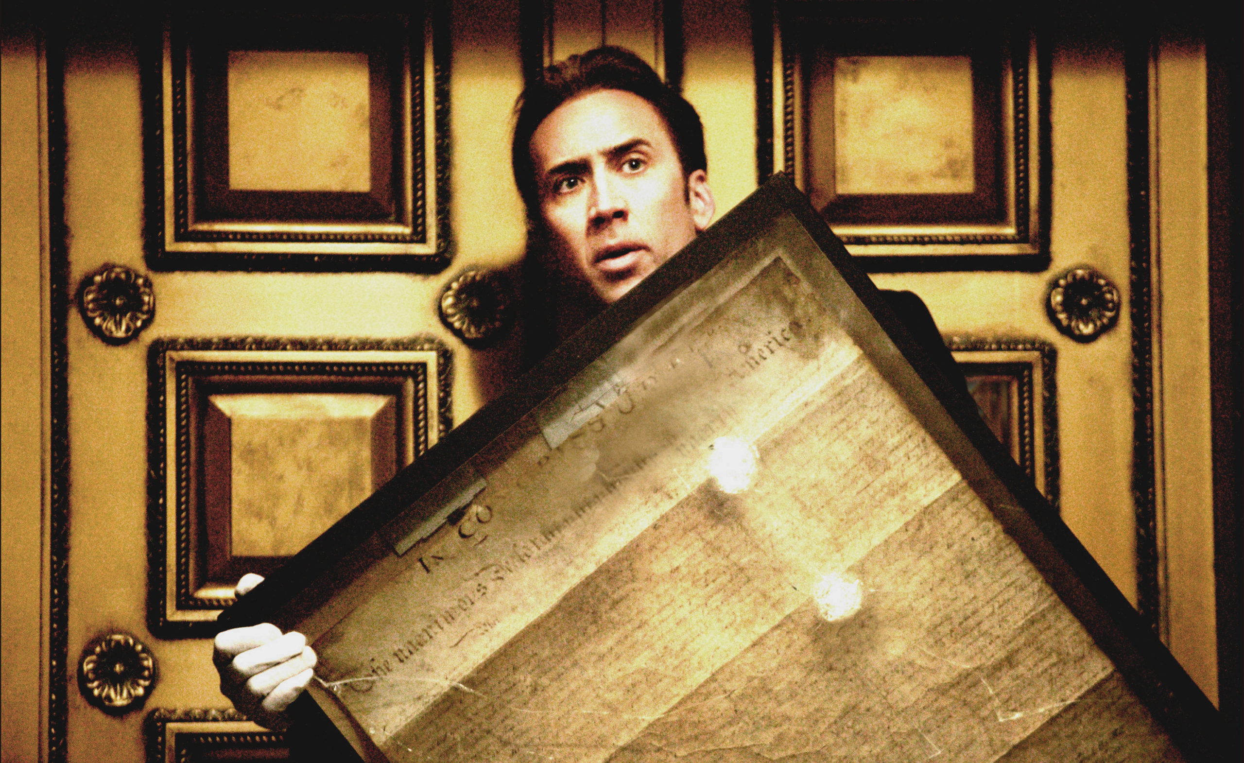 National Treasure: Nic Cage stares ahead, frightened, while holding the bullet-ridden protective casing surrounding the Declaration of Independence.