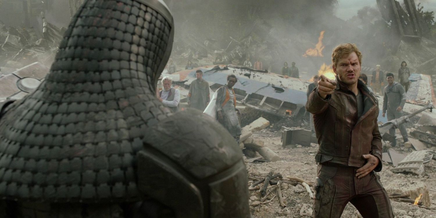 Peter Quill, pointing a finger, dance battles Ronan in the rubble of their crash landing.