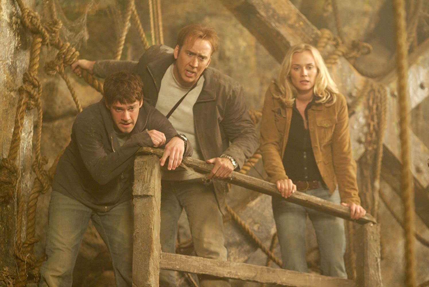 National Treasure: Riley Poole, Ben Gates, and Dr. Abigail Chase stand precariously on an ancient wooden structure.
