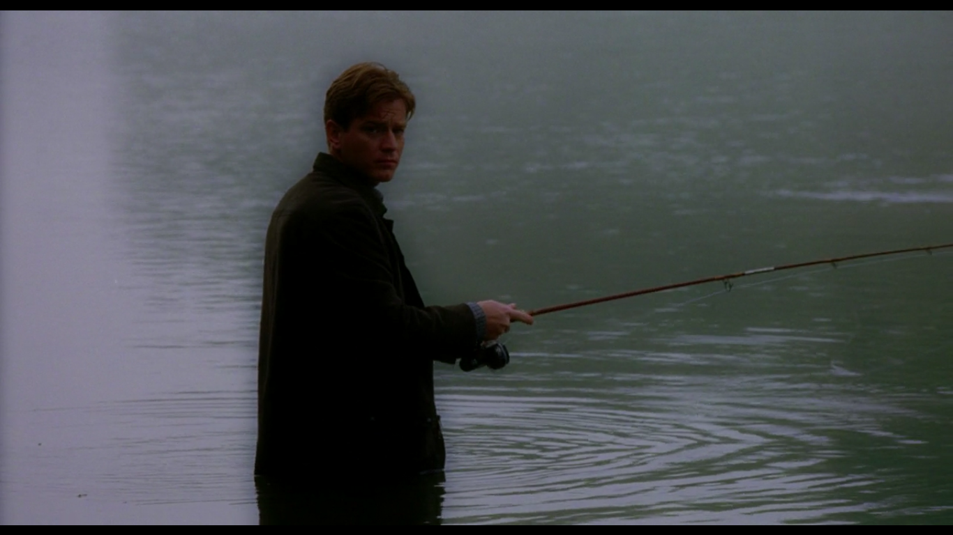 Edward Bloom stands in a swamp while fishing.