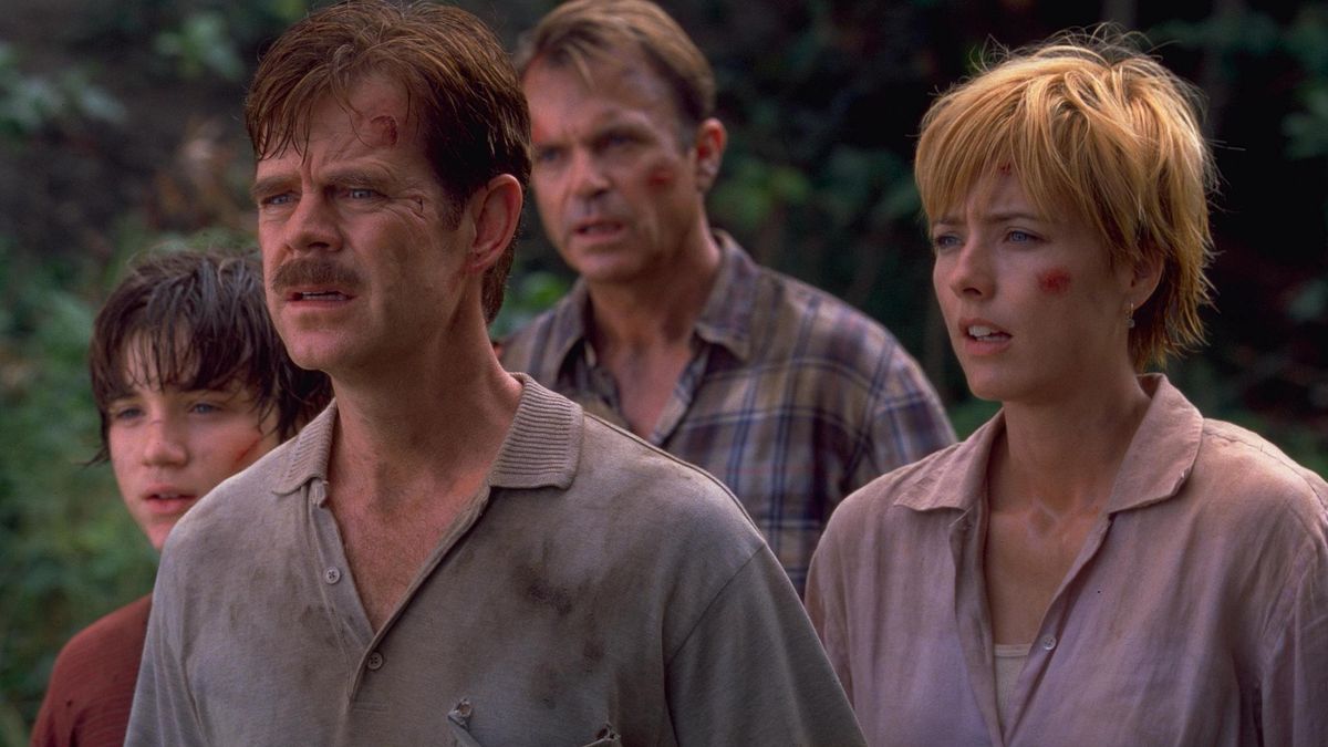 Erik, Paul, and Amanda Kirby with Dr. Alan Grant in the background, facing off a Velociraptor in Jurassic Park III.