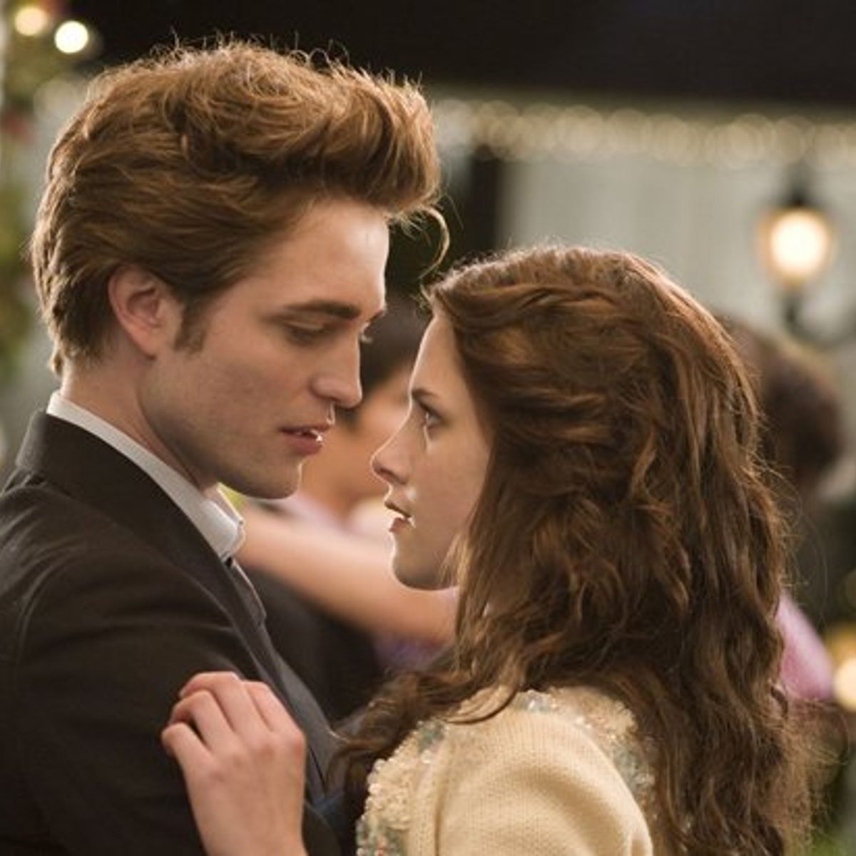 Twilight couple Edward Cullen and Bella Swan dancing with each other at her high school prom. 
