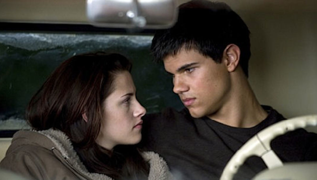Bella Swan and Jacob Black sitting in a car together and looking at each other lovingly.