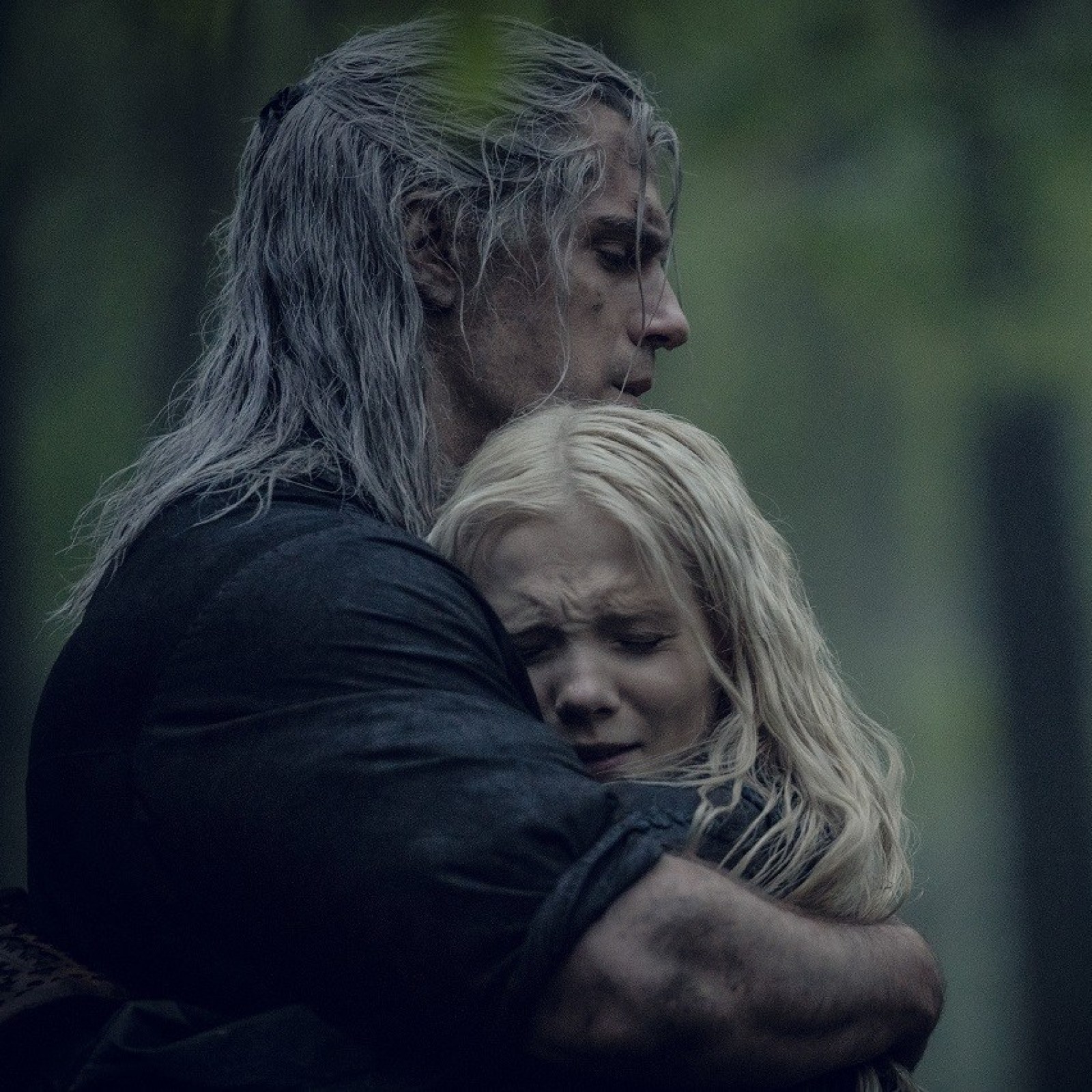 Henry Cavill as Geralt of Rivia hugs Freya Allen as Ciri in Netflix's The Witcher