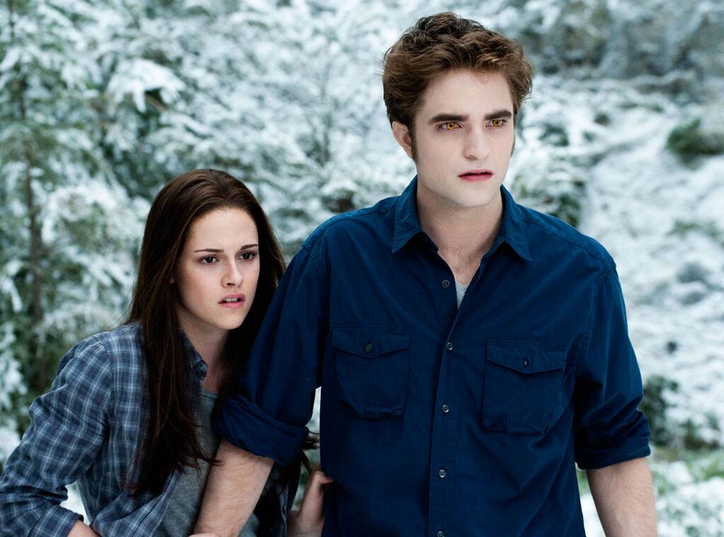 Edward Cullen and Bella Swan standing in a snowy forest.