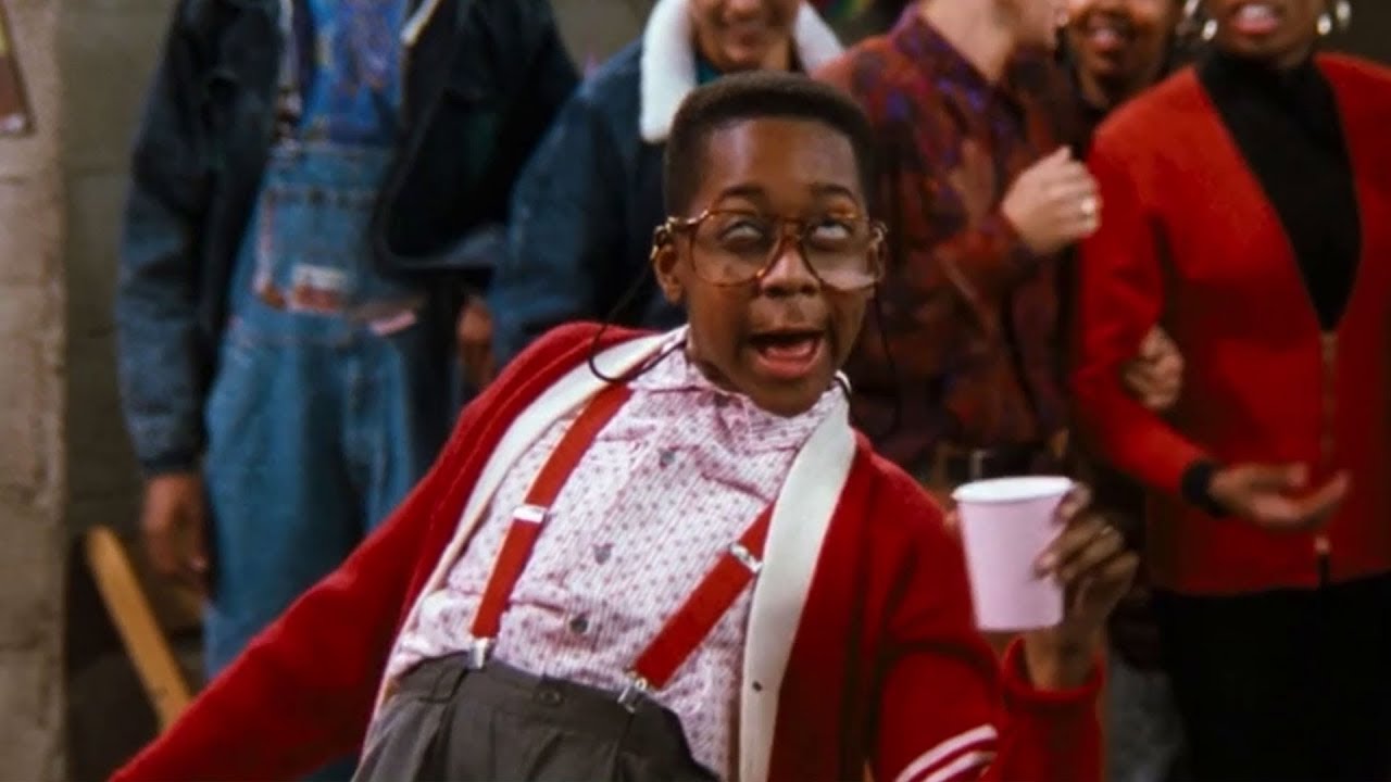 A drunk Steve holds a cup in his hand making a goofy face in Family Matters.