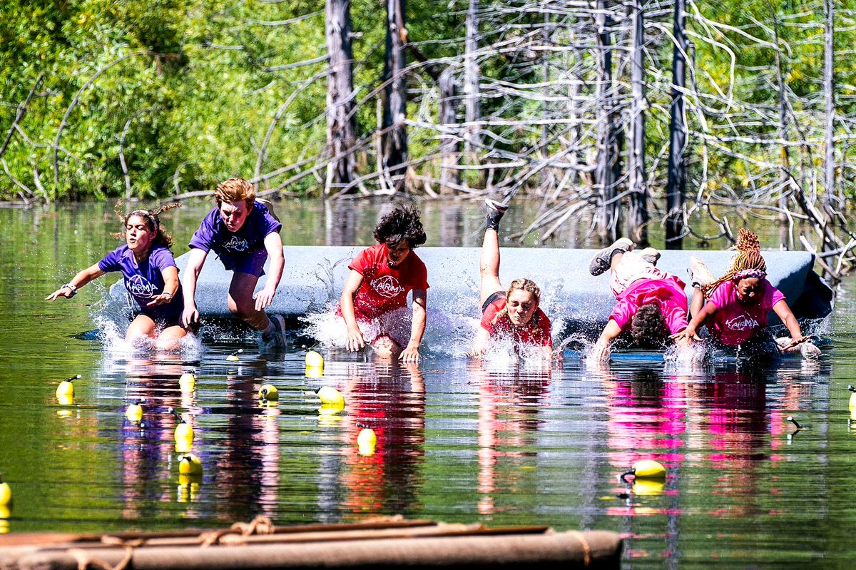 The Purple Team (left), Red Team (middle) and Pink Team (right) all swim in the water for a mission in Karma.