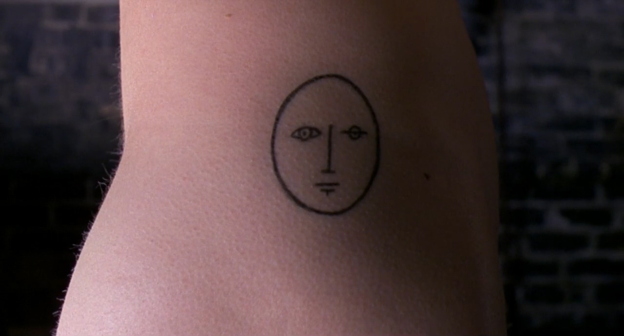 A tattoo of a complete face on Hedwig's body. It is one of the last scenes from "Hedwig and the Angry Inch."