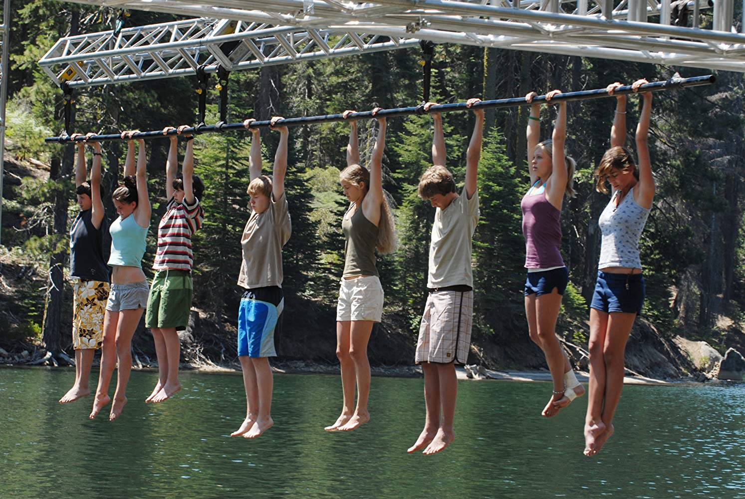 The contestants of Endurance: High Sierras hang from a pole in the Right to Stay challenge.