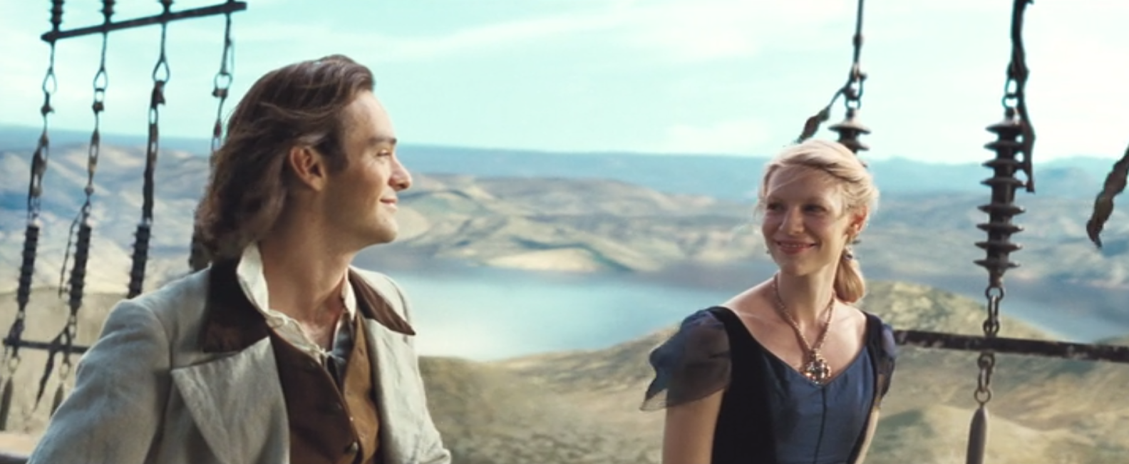 Tristan (played by Charlie Cox) and Yvaine (played by Claire Danes) on the deck of Captain Shakespeare's ship. They are smiling and looking at each other.