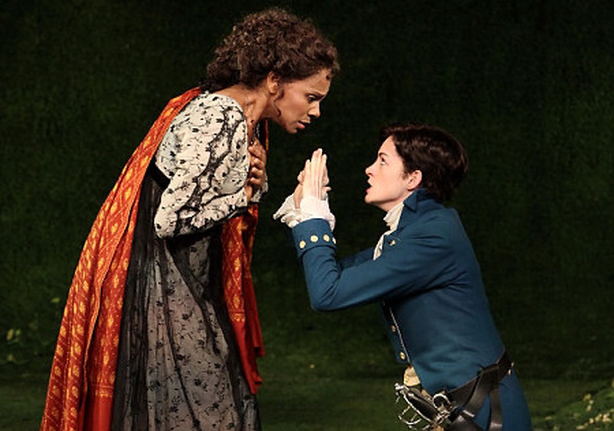 Olivia looks down at a Viola on her knees, in an Elizabethan Era set Twelfth Night. 