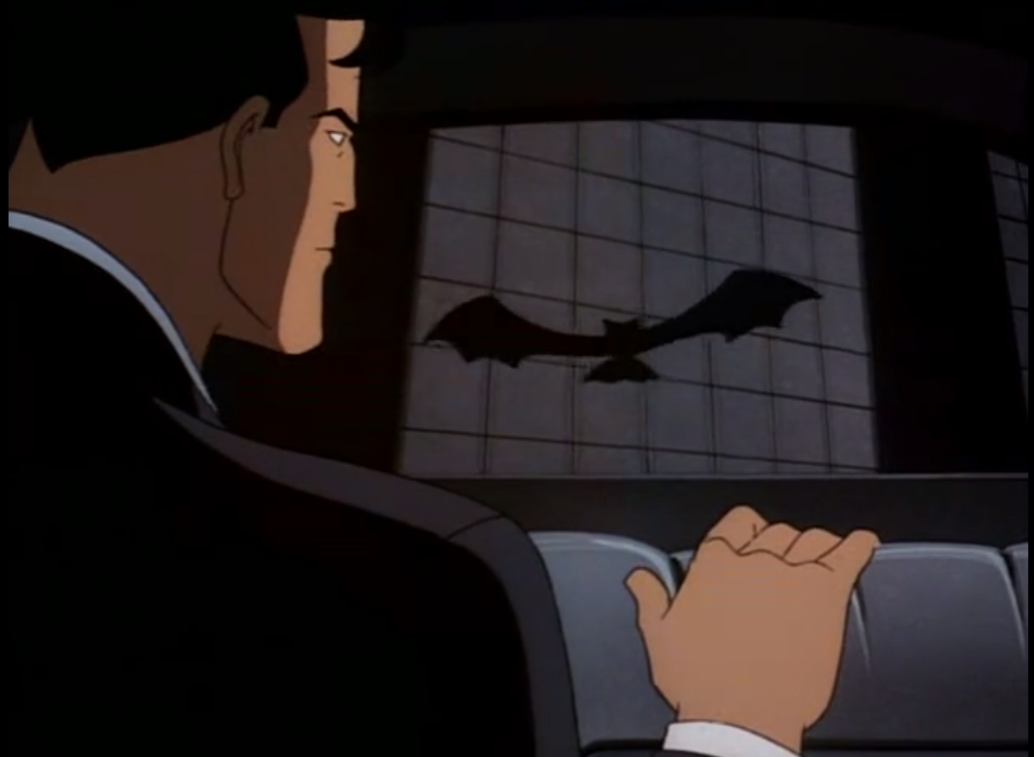 Bruce Wayne notices a contraption in the shape of a bat that Charlie Collins uses to signal for help in "Joker's Favor" from Batman: The Animated Series.