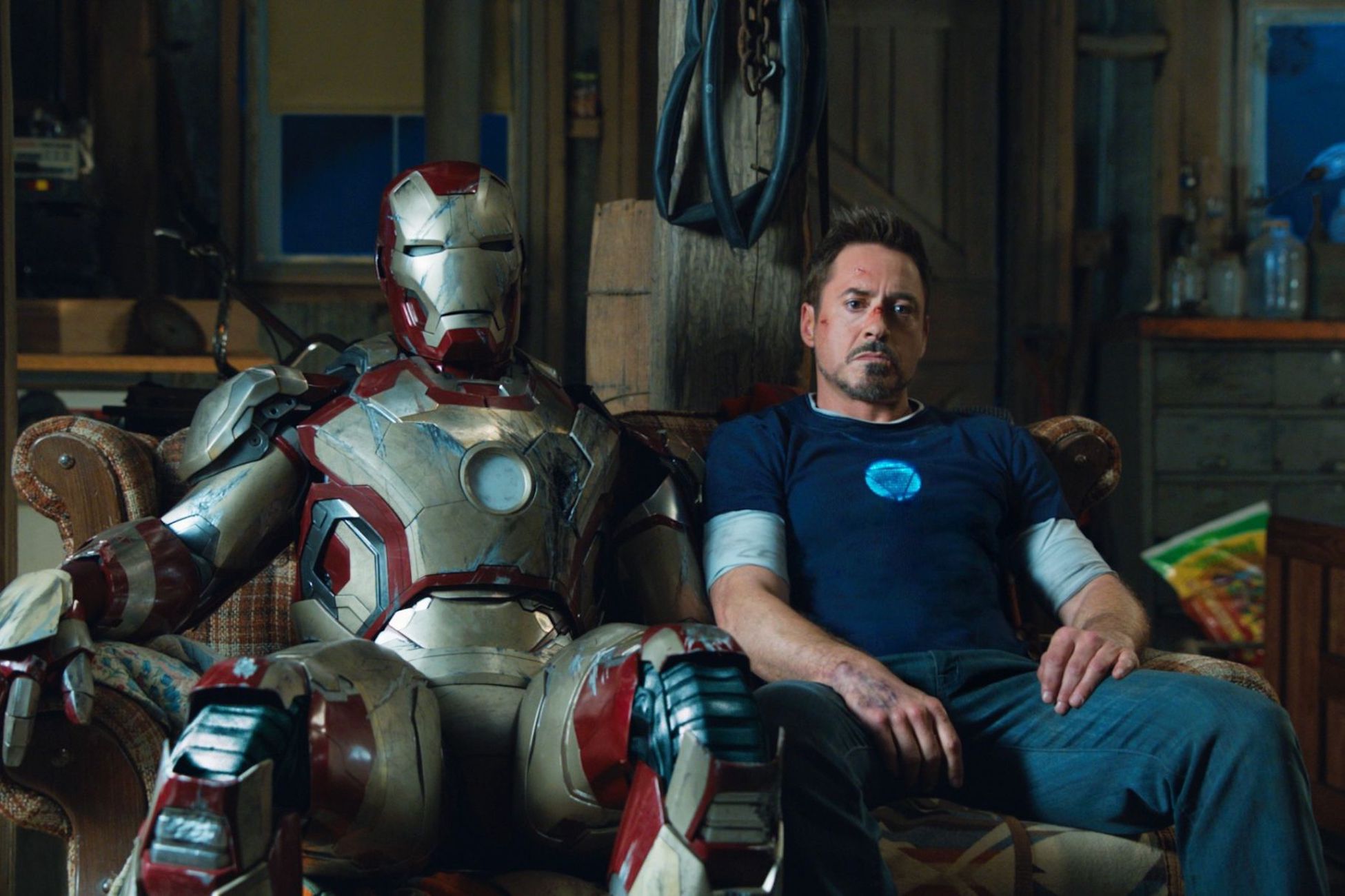 This shot is from a scene in Iron Man 3 (2013) where Tony Stark was sitting with his iron man suit on the couch, contemplating.