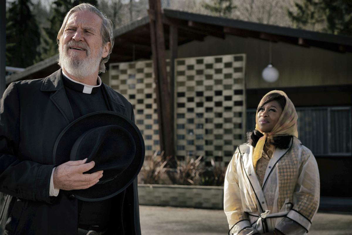 Father Daniel Flynn and Darlene Sweet look towards the sky in front of the El Royale.