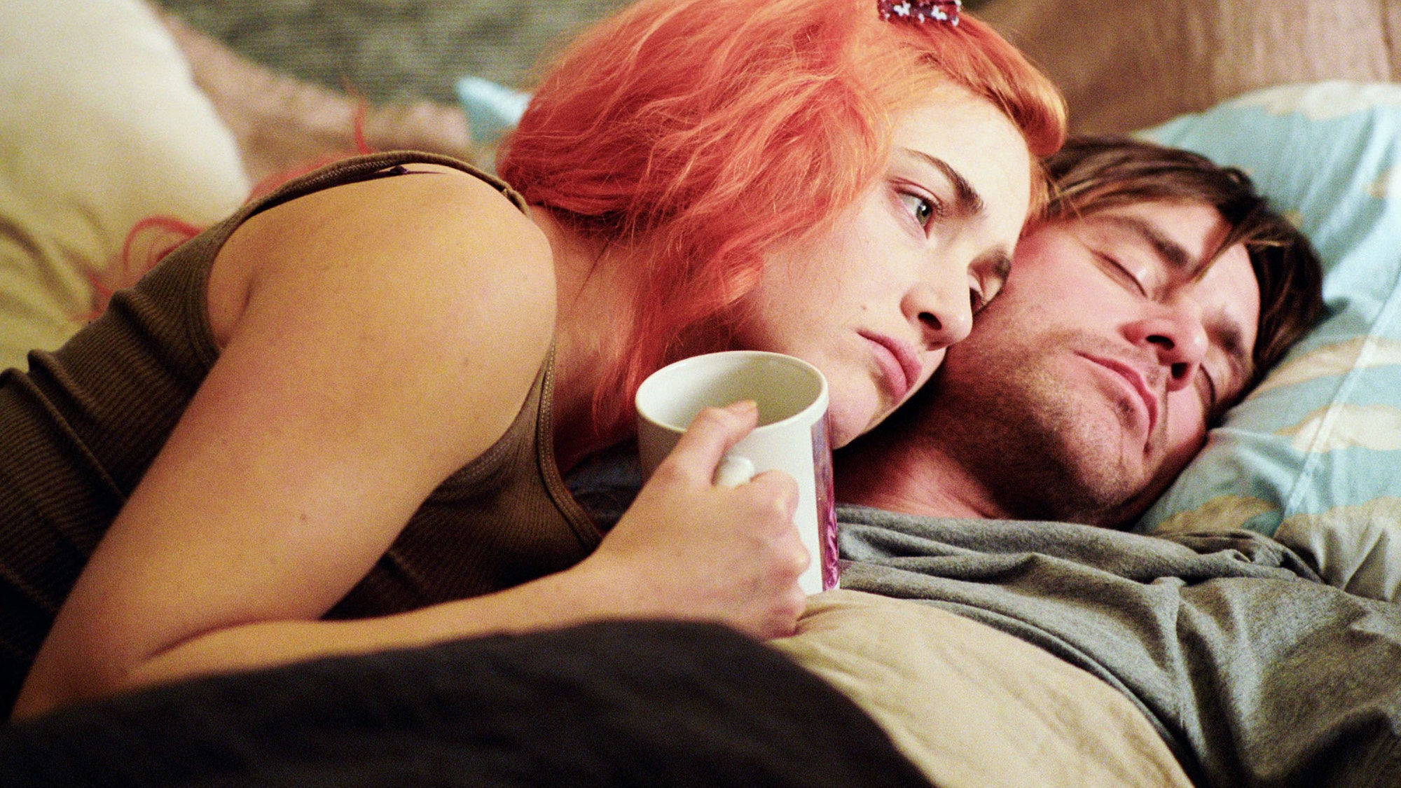 Joel (Jim Carrey) and Clementine (Kate Winslet) lay together on a bed in Charlie Kaufman's movie Eternal Sunshine Of The Spotless Mind.