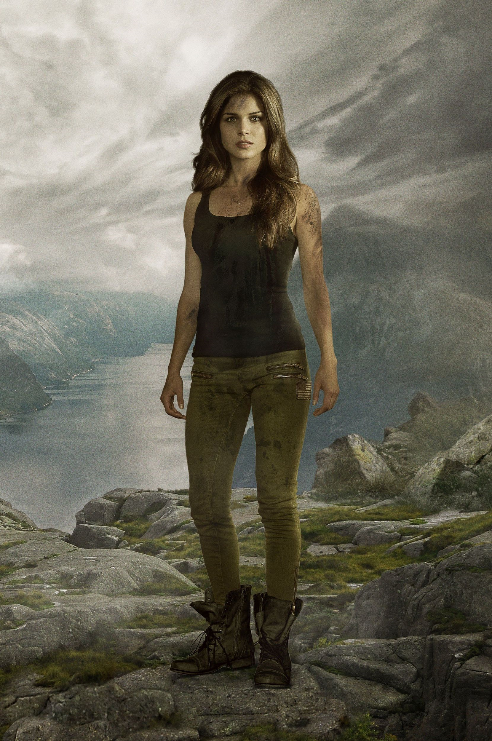 Octavia Blake stands on a rocky cliff in an unfamiliar land in "The 100" season 1 promo shot.